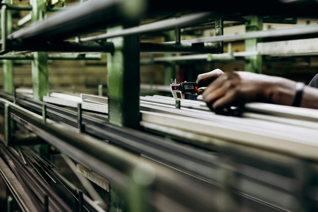 Structural aluminium pipes on shelves in building warehouse